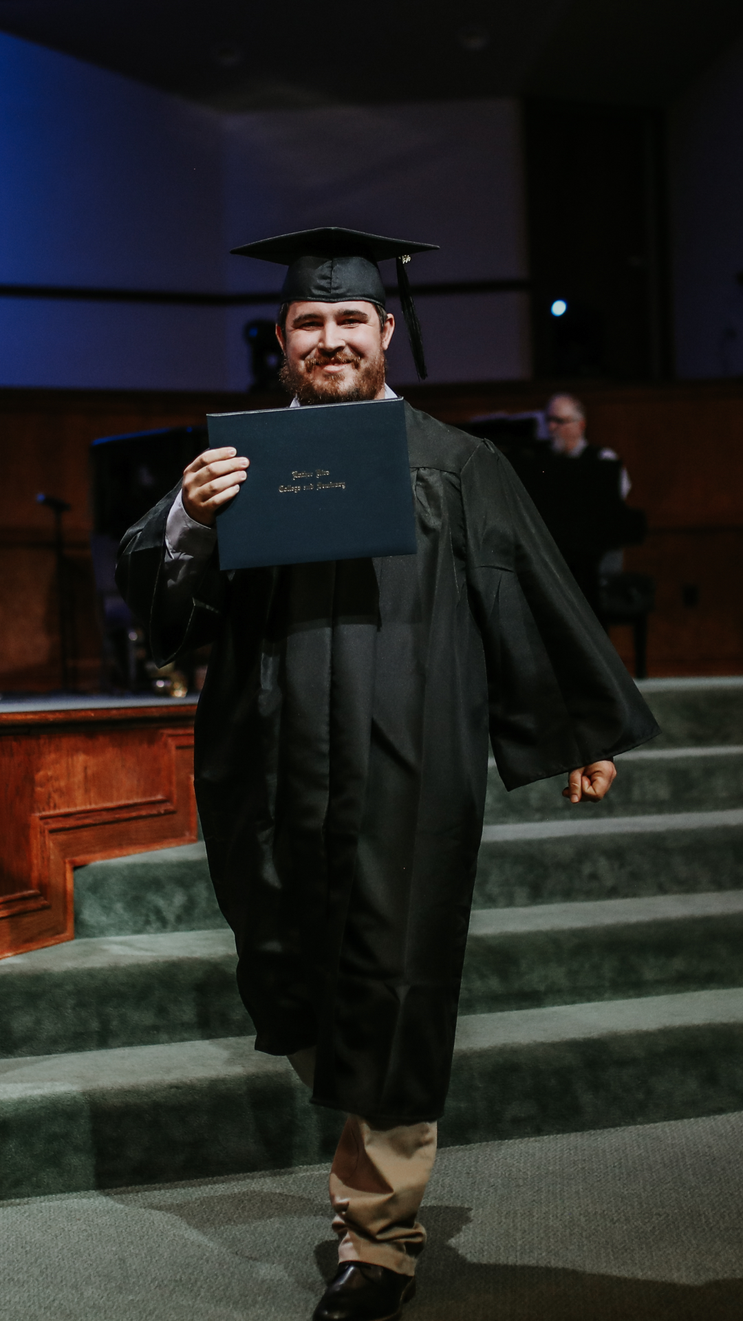 Man walking across graduation stage